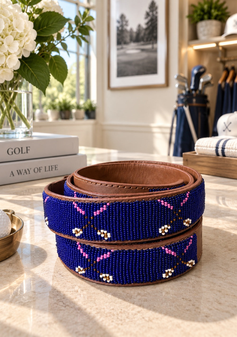 Two Clubs beaded golf belt for women, royal blue with crossed pink clubs on tan leather