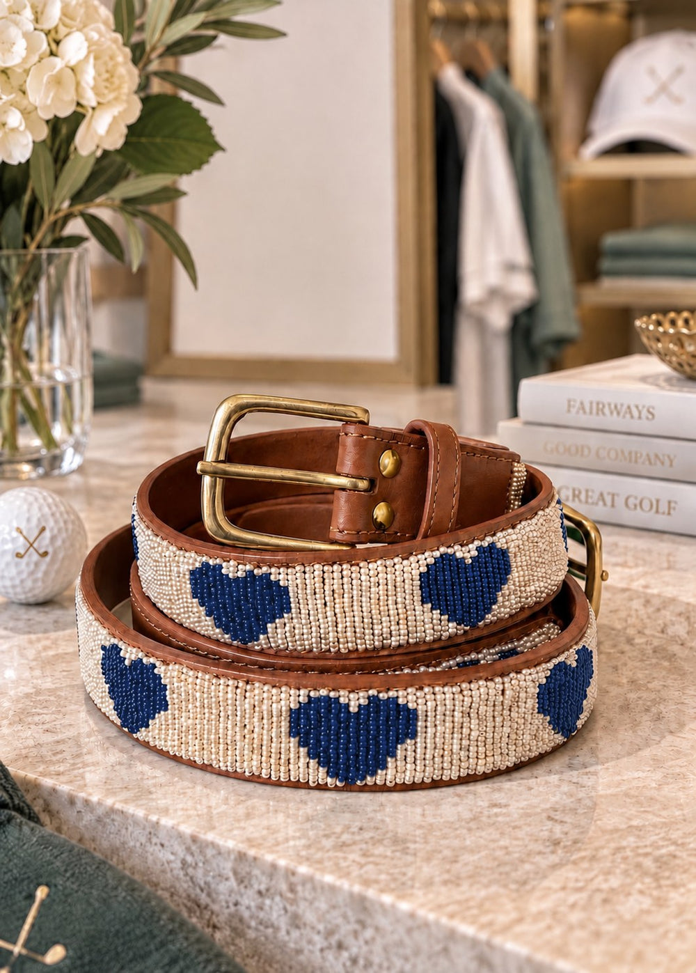 Ace of Hearts beaded golf belt for women with navy beaded hearts on cream, tan leather and brass buckle